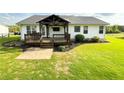 Large, level backyard with a covered deck, offering plenty of space for outdoor activities at 273 Crowe Springs Nw Rd, Cartersville, GA 30121