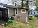 Back exterior of home with siding, steps leading to the back door, and lower-level entrance at 4632 Burks Rd, Forest Park, GA 30297