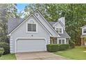 Charming home featuring stone accents, a two-car garage, and a well-maintained lawn at 995 Litchfield Pl, Roswell, GA 30076