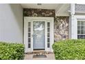 Welcoming front door with decorative stone accents and a well-maintained landscape at 995 Litchfield Pl, Roswell, GA 30076