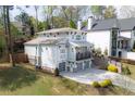 Rear view of the luxury home highlighting a walkout balcony, garage, and professionally landscaped yard at 3080 Dickson Ne St, Brookhaven, GA 30319