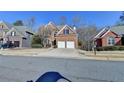 Charming two-story brick home with a well-manicured lawn, two-car garage, and a welcoming front entrance at 1924 Wilkenson Xing, Marietta, GA 30066