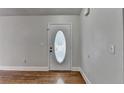 Bright entryway featuring beautiful hardwood floors and decorative front door at 5880 April Dr, Sugar Hill, GA 30518