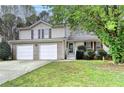 Charming two-story home with a two-car garage and a well-manicured front yard at 5880 April Dr, Sugar Hill, GA 30518