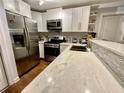 Modern kitchen featuring stainless steel appliances, white cabinets, and a stylish countertop at 1118 Magnolia Se Way, Smyrna, GA 30082