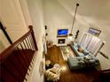 Upstairs view of a living room with hardwood floors, a fireplace and a comfortable blue sectional sofa at 1118 Magnolia Se Way, Smyrna, GA 30082
