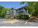 Multi-level condo building shows three stories and balconies, as well as parking and landscaping at 1602 Gettysburg Pl, Sandy Springs, GA 30350
