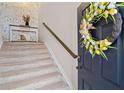 Inviting entryway with a decorative wreath on the door and a staircase leading to the upper level at 262 Royal Crescent Ter, Canton, GA 30115