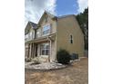 Side view of the two-story home showing siding, stone accents, and exterior features at 1112 Gather Dr, Lawrenceville, GA 30043