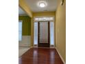 Inviting foyer with hardwood floors and transom windows over the front door at 1112 Gather Dr, Lawrenceville, GA 30043