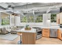 Modern kitchen with stainless steel appliances, stylish island with seating, and ample natural light at 400 Village Ne Pkwy # 203, Atlanta, GA 30306