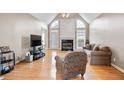 Bright living room with hardwood floors, large windows, fireplace, and vaulted ceilings at 4093 Tritt Homestead Dr, Marietta, GA 30062