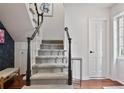 Elegant staircase with plush carpeting, dark wood banister, and white trim, plus hardwood flooring and a small bench at 4620 Wieuca Ne Rd # 24, Atlanta, GA 30342