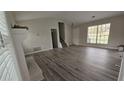Bright living room with gray laminate floors, fireplace, and large windows at 890 Shiloh Ridge Nw Run, Kennesaw, GA 30144