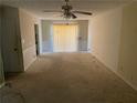 Spacious living room with sliding glass doors and neutral carpet, offering a blank canvas for personal design touches at 1511 Stonewood Dr, Norcross, GA 30093