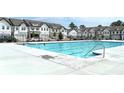 Community pool surrounded by townhomes and black metal fencing provides a place to cool off at 421 Auburn Valley Way, Auburn, GA 30011