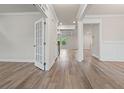 Bright foyer with hardwood flooring, white trim, and an elegant doorway at 4229 Brookmont Way, Auburn, GA 30011