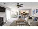 This living room features an open concept with a dining room and kitchen, and a fireplace with large sliding glass doors at 68 Hampshire Ct, Avondale Estates, GA 30002