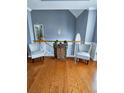 Upstairs hallway with hardwood floors, a decorative barrel, and two chairs at 2669 Ambria Dr, Buford, GA 30519