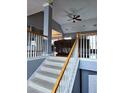Interior shot of staircase with wooden handrail, neutral carpeting, and gray walls at 2669 Ambria Dr, Buford, GA 30519