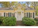 Close up of a delightful home featuring classic shutters, sconces, and a neatly maintained lawn at 28 Exeter Rd, Avondale Estates, GA 30002