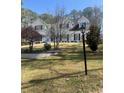 Beautiful two-story home featuring mature trees and manicured lawn at 4748 Arcado Sw Rd, Lilburn, GA 30047