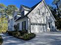Spacious home with a two-car garage, white brick facade, and well-maintained landscaping at 4748 Arcado Sw Rd, Lilburn, GA 30047