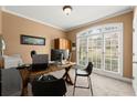 Well-lit home office featuring a large window and functional workspace at 1060 Meadow Brook Dr, Woodstock, GA 30188