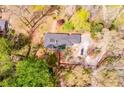 Aerial view of property showcasing the roof, driveway and tree lined lot at 1714 Highland Pl, Decatur, GA 30035