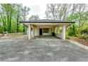 Spacious carport with concrete flooring and brick columns, providing ample parking space at 1714 Highland Pl, Decatur, GA 30035