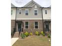 Attractive townhome with brick facade, gray siding, and well-maintained landscaping at 1282 Ainsworth Aly, Sugar Hill, GA 30518