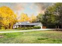 Inviting home with spacious front yard and long driveway, surrounded by mature trees at 20 Riverbrooke Rd, Covington, GA 30016