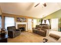 Cozy living room with stone fireplace, comfortable seating, and abundant natural light at 20 Riverbrooke Rd, Covington, GA 30016