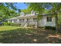 Inviting one-story home with a lovely front porch and mature landscaping at 320 Creek Side Ct, Mcdonough, GA 30252