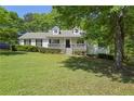 Beautiful single-story home featuring a covered porch and lush green front yard at 320 Creek Side Ct, Mcdonough, GA 30252