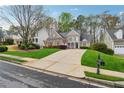 Charming brick home featuring lush green lawn and a long driveway at 4847 Sara Creek Way, Sugar Hill, GA 30518
