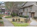 Charming townhome community showcasing manicured lawns, lush landscaping and a sidewalk to front door at 508 Cumberland Se Ct, Smyrna, GA 30080