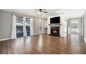 Bright living room with hardwood floors, fireplace, and sliding glass doors to the outdoor balcony at 508 Cumberland Se Ct, Smyrna, GA 30080