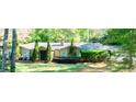 Traditional single-Gathering home with a manicured lawn, mature landscaping, and attached garage at 2701 East Mill Sw Way, Conyers, GA 30094