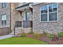 Charming front entrance with brick steps, landscaping, and a welcoming door at 3764 Sage Park Way, Suwanee, GA 30024