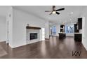 Spacious living room with a fireplace, hardwood floors, and ample natural light at 3764 Sage Park Way, Suwanee, GA 30024