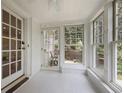 Bright sunroom featuring white-painted floors, lots of natural light and views of the surrounding greenery at 1794 Charline Ne Ave, Atlanta, GA 30306