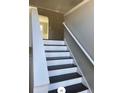 Interior view of stairs with white risers and dark wood treads leading up to the next level at 2250 Camp Town Way, Lawrenceville, GA 30044