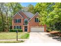 Charming two-story brick home with a well-manicured lawn, mailbox, and attached two car garage at 3225 Warren Creek Sw Dr, Hiram, GA 30141