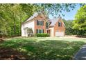 Charming two-story brick home with a well-manicured lawn, and attached two car garage at 3225 Warren Creek Sw Dr, Hiram, GA 30141