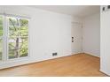 Bright, sunny living room with gleaming hardwood floors and a large window with a lovely view at 112 Bernice Dr, Lawrenceville, GA 30045