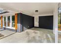 Spacious carport featuring modern lights, direct house access, and durable concrete flooring at 2318 Plantation Dr, Atlanta, GA 30344
