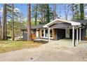 Charming home featuring a brick facade, orange shutters and a convenient carport at 2318 Plantation Dr, Atlanta, GA 30344