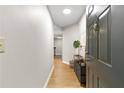 Hallway view shows the open door, modern decor, and wood-look flooring at 1280 W Peachtree Nw St # 1712, Atlanta, GA 30309