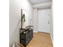 Light and airy hallway featuring vinyl flooring, a white door, and storage unit with decor at 1280 W Peachtree Nw St # 1712, Atlanta, GA 30309